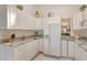Bright eat-in kitchen, granite countertops, white cabinets, and stainless steel appliances at 2383 Harbour Oaks Dr, Longboat Key, FL 34228