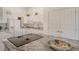 Modern kitchen with white cabinets, granite countertops, and breakfast bar at 2383 Harbour Oaks Dr, Longboat Key, FL 34228