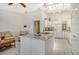 Kitchen with white cabinets, granite countertops, and an island with cooktop at 2383 Harbour Oaks Dr, Longboat Key, FL 34228