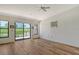 Light and airy living room with hardwood floors and sliding doors to balcony at 2383 Harbour Oaks Dr, Longboat Key, FL 34228