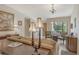 Living room featuring a sofa, comfortable armchairs and a view to entryway at 2383 Harbour Oaks Dr, Longboat Key, FL 34228