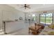 Open living space with kitchen island, stainless steel appliances and golf course view at 2383 Harbour Oaks Dr, Longboat Key, FL 34228