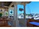 Outdoor patio area with waterfront views and wooden tables at 2383 Harbour Oaks Dr, Longboat Key, FL 34228