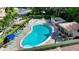 Aerial view of community pool and spa with surrounding landscape at 2383 Harbour Oaks Dr, Longboat Key, FL 34228