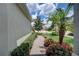 Brick pathway through a nicely landscaped yard, showcasing a home exterior at 4826 Maymont Park Cir, Bradenton, FL 34203