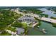 Aerial view of waterfront condo building with pool and boat slips at 516 Tamiami S Trl # 102, Nokomis, FL 34275