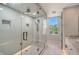 Bathroom with walk-in shower and window at 516 Tamiami S Trl # 102, Nokomis, FL 34275