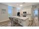 Modern kitchen with white cabinets, marble countertops, and island at 516 Tamiami S Trl # 102, Nokomis, FL 34275