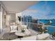 Expansive balcony with outdoor furniture and water views at 555 Quay Cmn # 1602, Sarasota, FL 34236