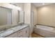 Elegant bathroom with double sinks, granite countertop, and a soaking tub at 2479 Grandview Dr, North Port, FL 34288