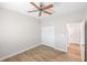 Bright bedroom with ceiling fan, wood-look floors, and ample closet space at 2479 Grandview Dr, North Port, FL 34288