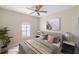 Spacious bedroom with a ceiling fan, large window, and neutral decor at 2479 Grandview Dr, North Port, FL 34288