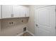 Bright laundry room with white cabinets and vinyl flooring at 2479 Grandview Dr, North Port, FL 34288