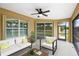 Relaxing screened porch with seating area and ceiling fan at 2479 Grandview Dr, North Port, FL 34288