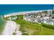 Aerial view of a coastal condo complex with oceanfront pool and beach access at 100 Sands Point Rd # 305, Longboat Key, FL 34228