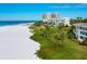 Aerial view of beachfront property with lush landscaping at 100 Sands Point Rd # 305, Longboat Key, FL 34228