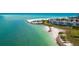 Drone view showcasing beachfront property with a white sand beach and clear water at 100 Sands Point Rd # 305, Longboat Key, FL 34228