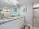 Modern bathroom with granite countertops, double sinks, and a walk-in shower at 100 Sands Point Rd # 305, Longboat Key, FL 34228