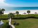 Beachfront access with lush landscaping and palmtrees at 100 Sands Point Rd # 305, Longboat Key, FL 34228