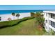 Stunning ocean view from grassy area with palm trees at 100 Sands Point Rd # 305, Longboat Key, FL 34228