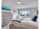 Spacious bedroom with water views and large TV at 100 Sands Point Rd # 305, Longboat Key, FL 34228