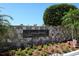 Sands Point community entrance with stone wall and landscaping at 100 Sands Point Rd # 305, Longboat Key, FL 34228