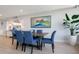 Condo dining area with modern table and blue chairs at 100 Sands Point Rd # 305, Longboat Key, FL 34228