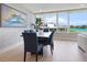 Bright dining room with water views and modern furnishings at 100 Sands Point Rd # 305, Longboat Key, FL 34228