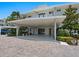 Modern building exterior with covered entryway and landscaping at 100 Sands Point Rd # 305, Longboat Key, FL 34228