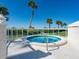 Relaxing hot tub with ocean views and palm trees at 100 Sands Point Rd # 305, Longboat Key, FL 34228