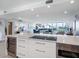 Open kitchen with island and water view at 100 Sands Point Rd # 305, Longboat Key, FL 34228