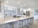 Modern kitchen with large island and bar seating at 100 Sands Point Rd # 305, Longboat Key, FL 34228