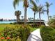 Landscaped walkway leading to waterfront with tropical plants at 100 Sands Point Rd # 305, Longboat Key, FL 34228