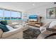 Modern living room with water views and comfortable seating at 100 Sands Point Rd # 305, Longboat Key, FL 34228