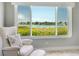 Relaxing living area featuring a comfy chair and stunning water views at 100 Sands Point Rd # 305, Longboat Key, FL 34228