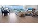 Open living and dining area with water views and modern decor at 100 Sands Point Rd # 305, Longboat Key, FL 34228