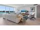 Living room with water views, white sofa, and modern decor at 100 Sands Point Rd # 305, Longboat Key, FL 34228