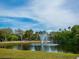 Serene park fountain with pond and lush landscaping at 100 Sands Point Rd # 305, Longboat Key, FL 34228
