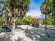 playground with swings, slides, and play structures at 100 Sands Point Rd # 305, Longboat Key, FL 34228