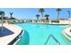Resort-style pool with ocean views and lounge chairs at 100 Sands Point Rd # 305, Longboat Key, FL 34228