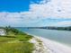 Scenic waterfront view with beach, bridge, and homes at 100 Sands Point Rd # 305, Longboat Key, FL 34228