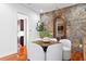 Cozy dining area with round table and stone accent wall at 3544 San Remo Ter, Sarasota, FL 34239