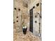 Spa-like shower with multiple shower heads and stone tile at 3544 San Remo Ter, Sarasota, FL 34239