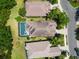 Aerial view of a home with a screened-in pool and meticulously maintained landscaping at 7249 Orchid Island Pl, Bradenton, FL 34202