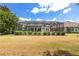 Wide shot of a backyard featuring a screened-in pool and lush greenery at 7249 Orchid Island Pl, Bradenton, FL 34202