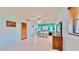 Bright bedroom with tiled floors, ceiling fan, and a view of the ensuite bathroom at 1415 Piedmont Rd, Venice, FL 34293