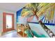 Bright entryway with coral door and tropical-themed wall mural at 1415 Piedmont Rd, Venice, FL 34293