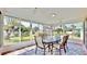 Spacious sunroom with glass walls offering a view of the backyard at 1415 Piedmont Rd, Venice, FL 34293