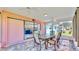 Enclosed patio with glass doors leading to kitchen and backyard at 1415 Piedmont Rd, Venice, FL 34293