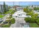 Aerial view of a white two-story house with a pool and ocean views at 149 Mckinley Dr, Sarasota, FL 34236